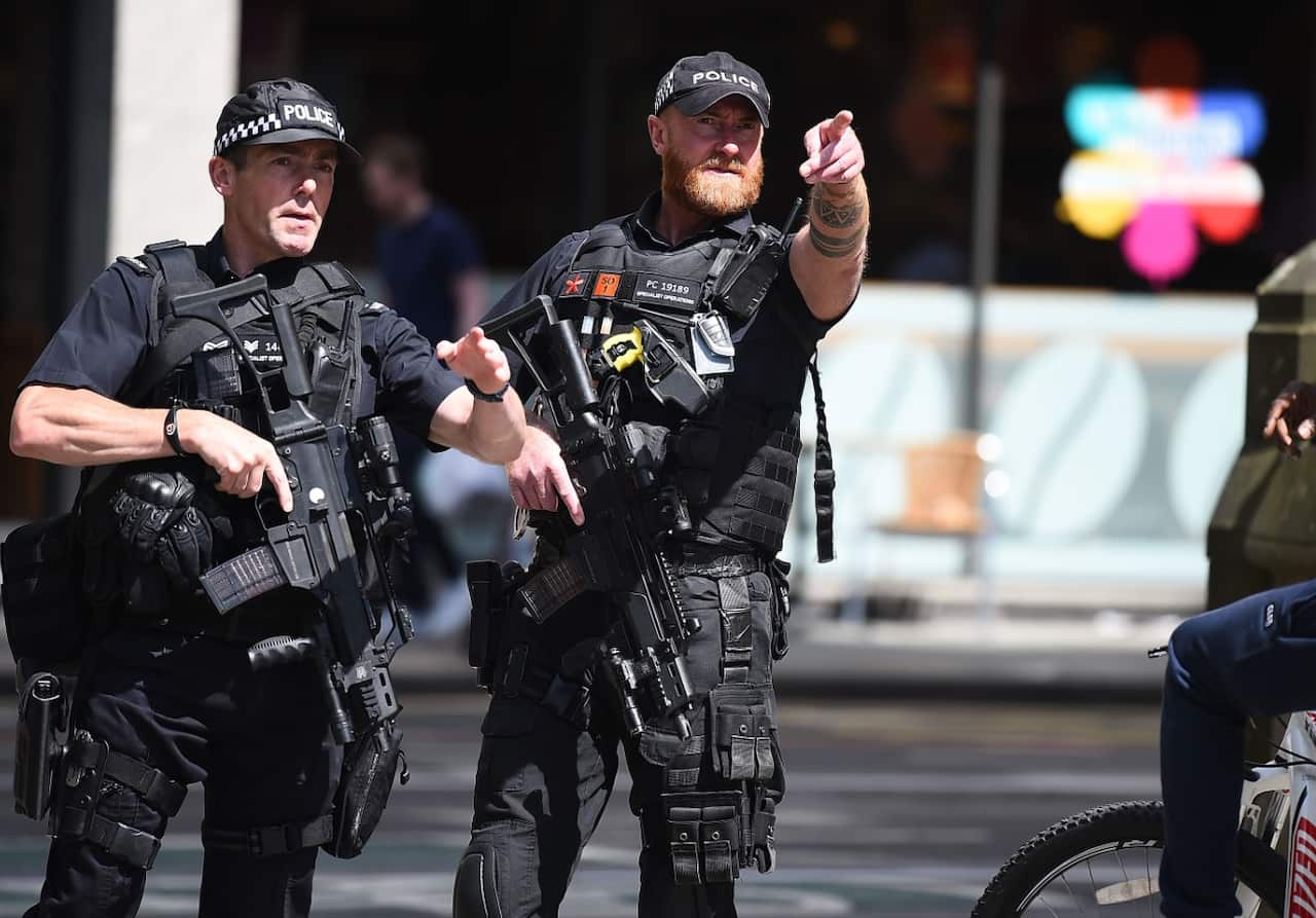 Police stand guard near the Manchester Arena