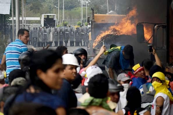  Protesters set on fire a truck as Venezuelan security forces guard the border and locals try to clear a path for humanitarian aid to enter Venezuela.