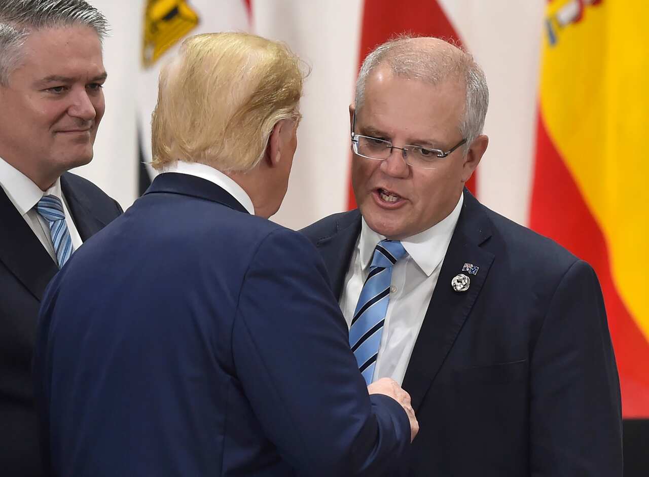 Australia's Prime Minister Scott Morrison (R) chats with US President Donald Trump (C).