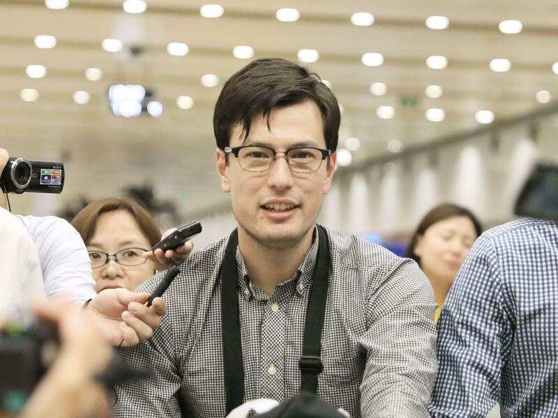 Alek Sigley arriving in China after being released by North Korea.