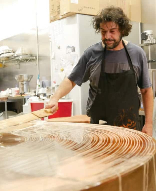 Mousa Kayat preparing knafeh at his Melbourne venue. 