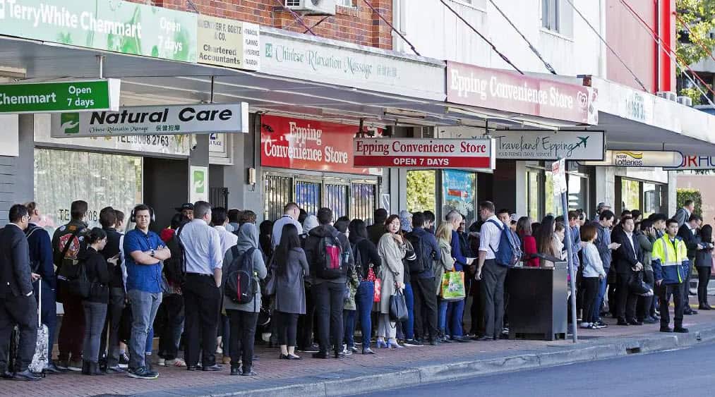 Commuters wait for buses at Epping train station in Sydney.