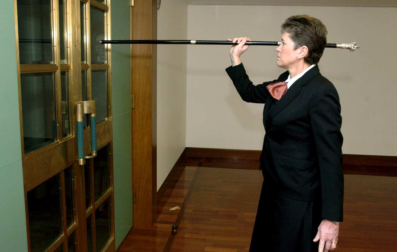 Canberra, November 16, 2004. Usher of the Black Rod Andrea Griffith knocks on the door of the House of representatives to summon members to the Senate chamber for the opening of Parliament. (AAP Image/Alan Porritt) NO ARCHIVING