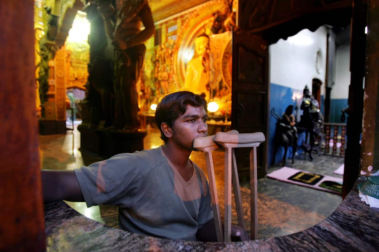 A civilian at a Buddhist temple in Colombo, June 2006, a country that suffered nearly two decades of civil war and the Asian tsunami.