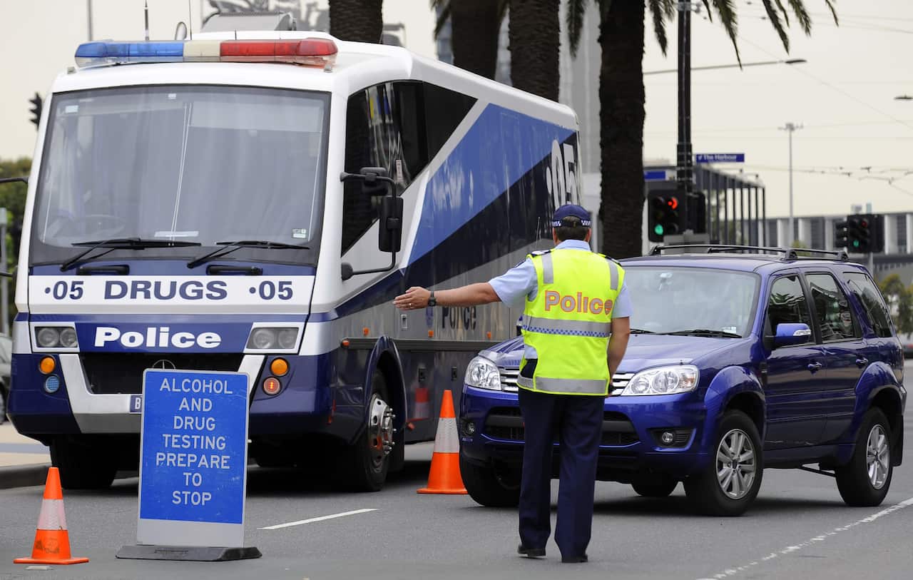 Police perfrom a random alcohol and drug test on a driver in the Dockalnds precinct in Melbourne, Friday, Nov. 21, 2009