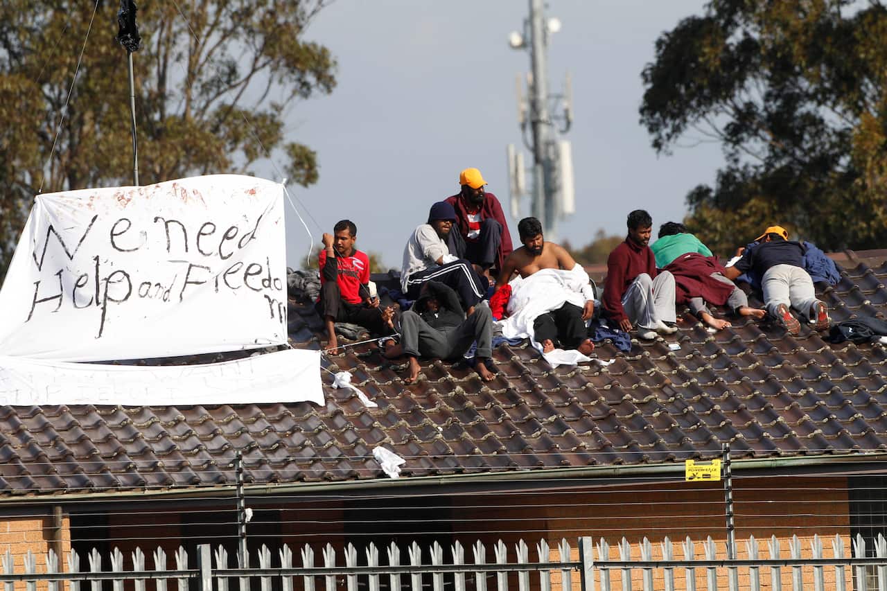 Asylum seekers hold a protest on the roof of the Villawood detention center in Sydney, Australia