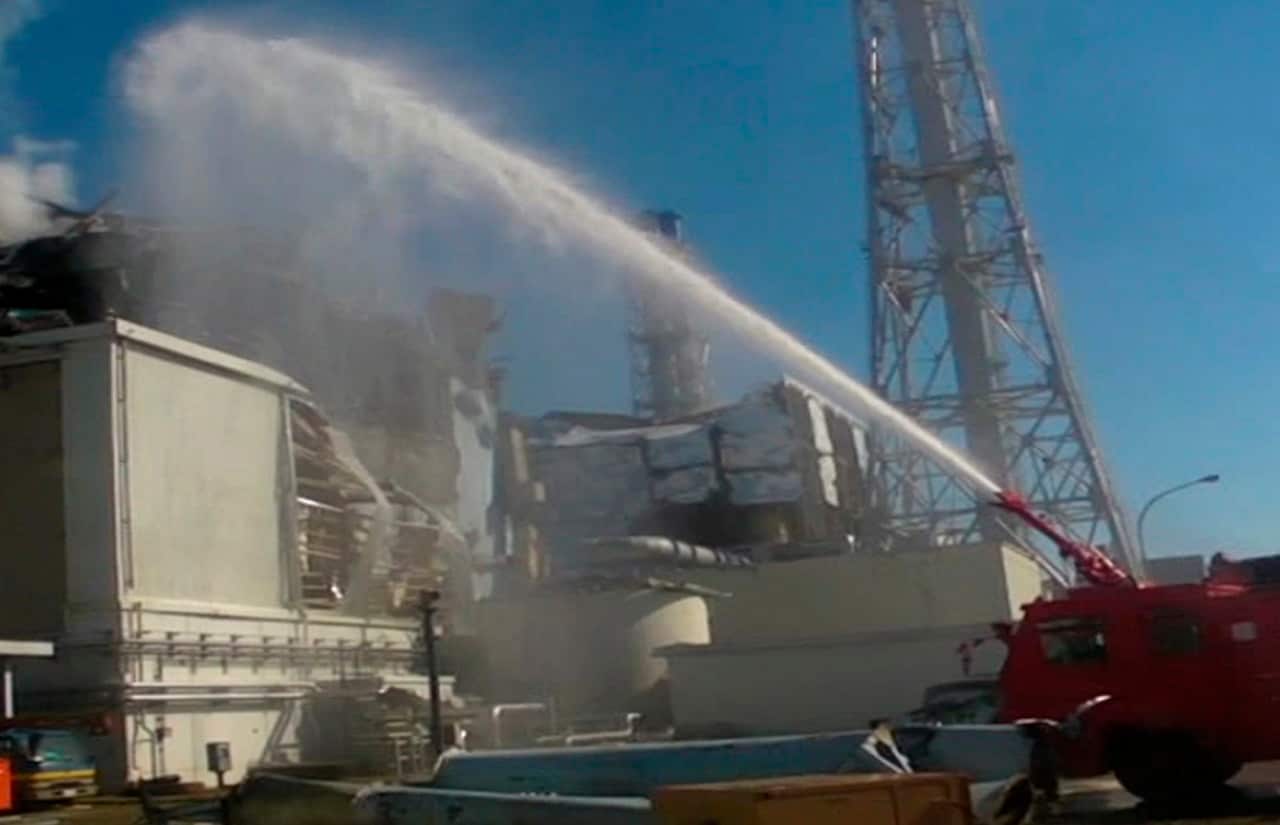 Fukushima Dai-ichi nuclear complex, March 18, 2011. Military fire attempt to prevent fuel from overheating and emitting dangerous levels of radiation.