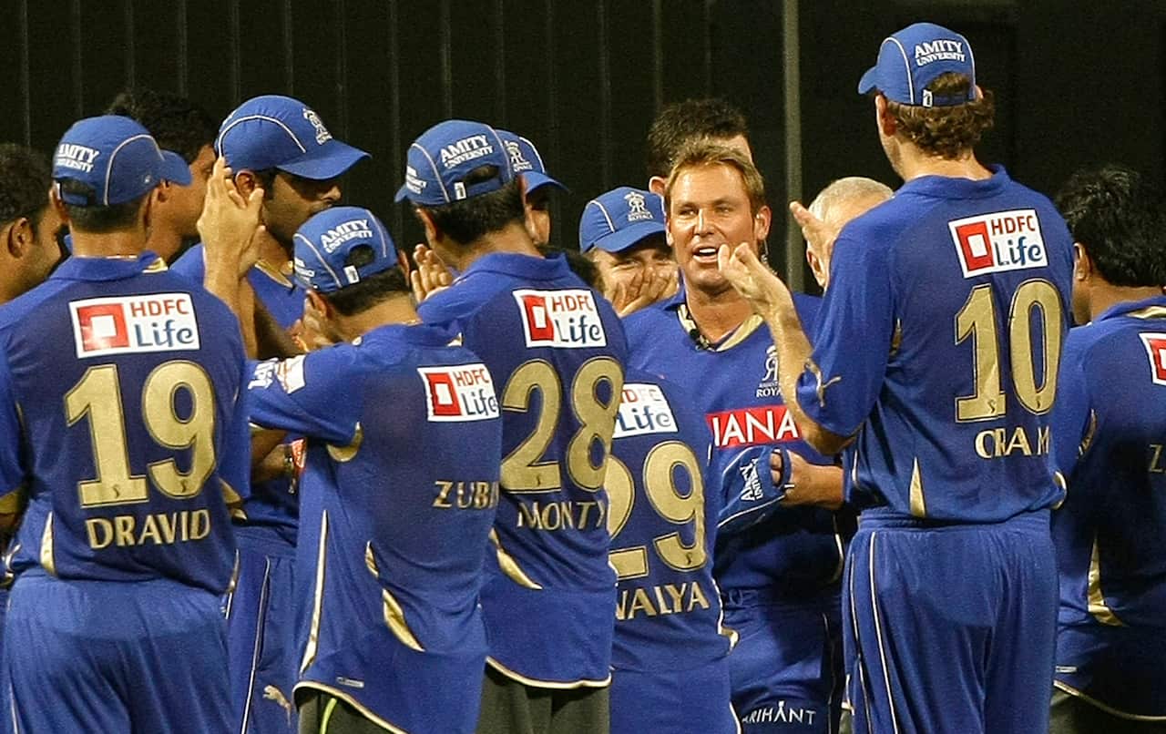 Teammates applaud as Rajasthan Royals' Shane Warne enters the field for the IPL match against Mumbai Indians in 2011.