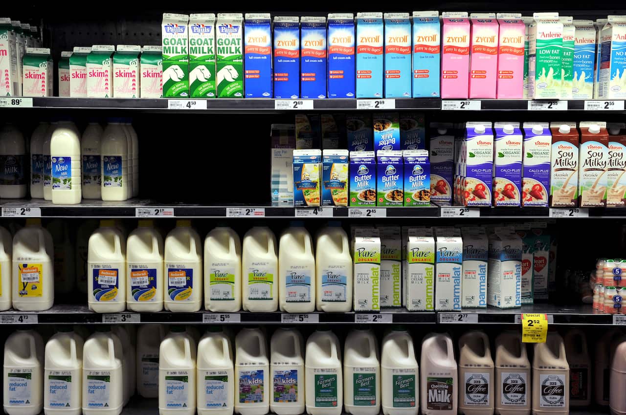 Milk lines the refrigerator shelves at a supermarket in Sydney on Monday, May 7, 2012. (AAP Image/Paul Miller) NO ARCHIVING
