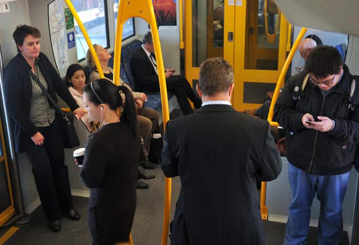 Commuters ride a city train in Sydney on Tuesday, May 15, 2012. (AAP Image/Paul Miller) NO ARCHIVING