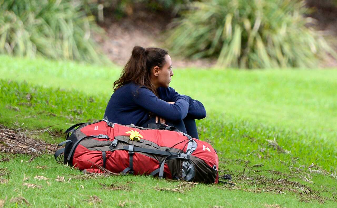 A backpacker sits in a park Brisbane, Wednesday, April 3, 2013. (AAP Image/Dan Peled) NO ARCHIVING
