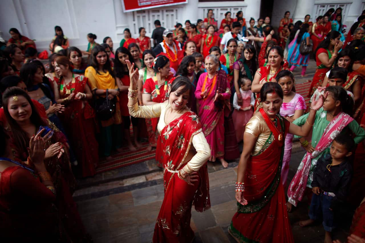 During this festival, married Hindu women observe day-long fast and pray for their husbands and a happy married life while those unmarried pray for a good husband. (AP Photo/Niranjan Shrestha)