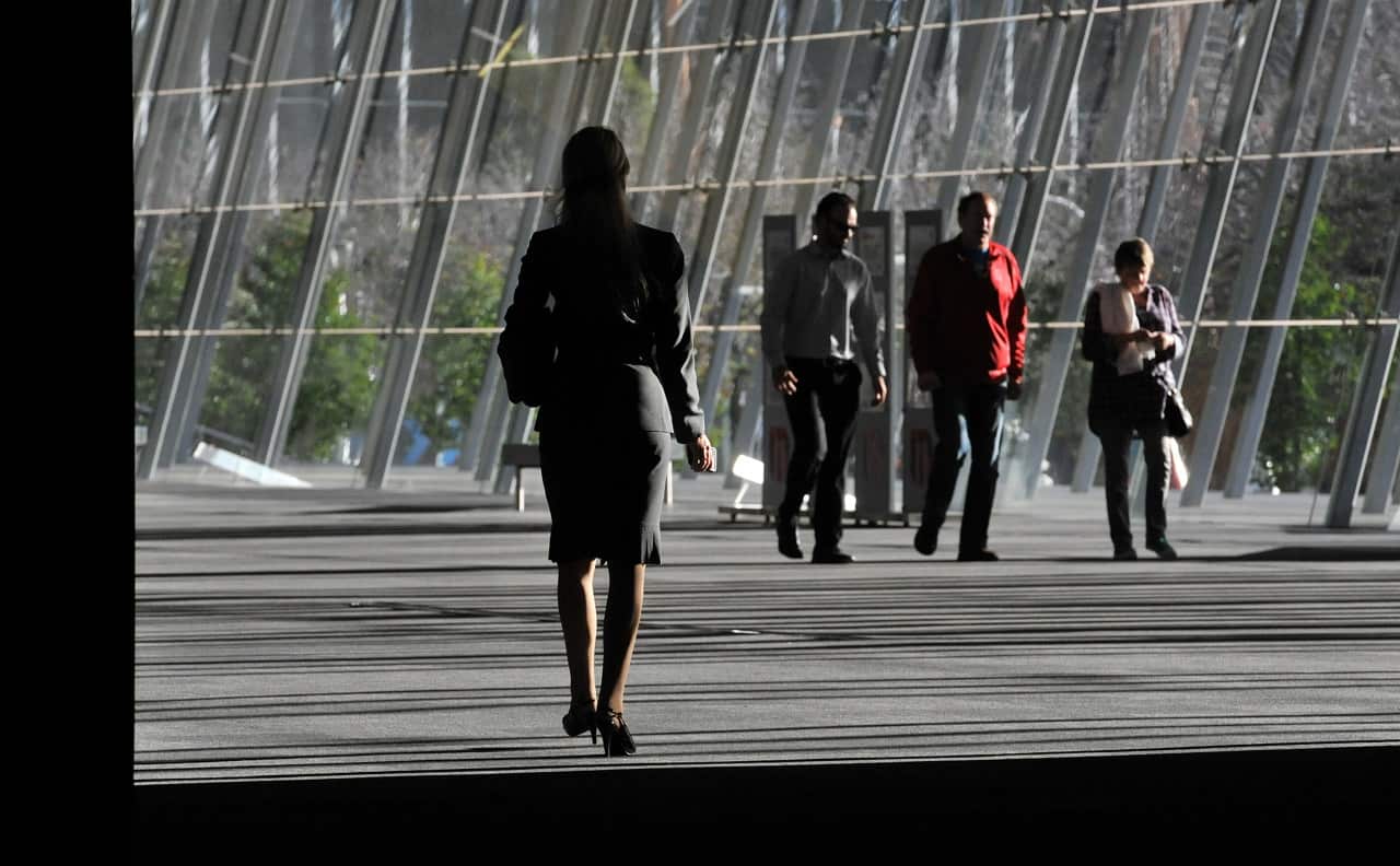A business woman is seen walking through the Melbourne Exhibition Centre.