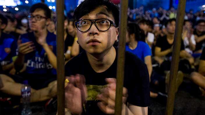 A protestor listens to a pro-democracy speech in the Admiralty district of Hong Kong