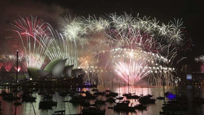 Fireworks explode over the Opera House and the Harbour Bridge during New Years Eve celebrations in Sydney, Australia,