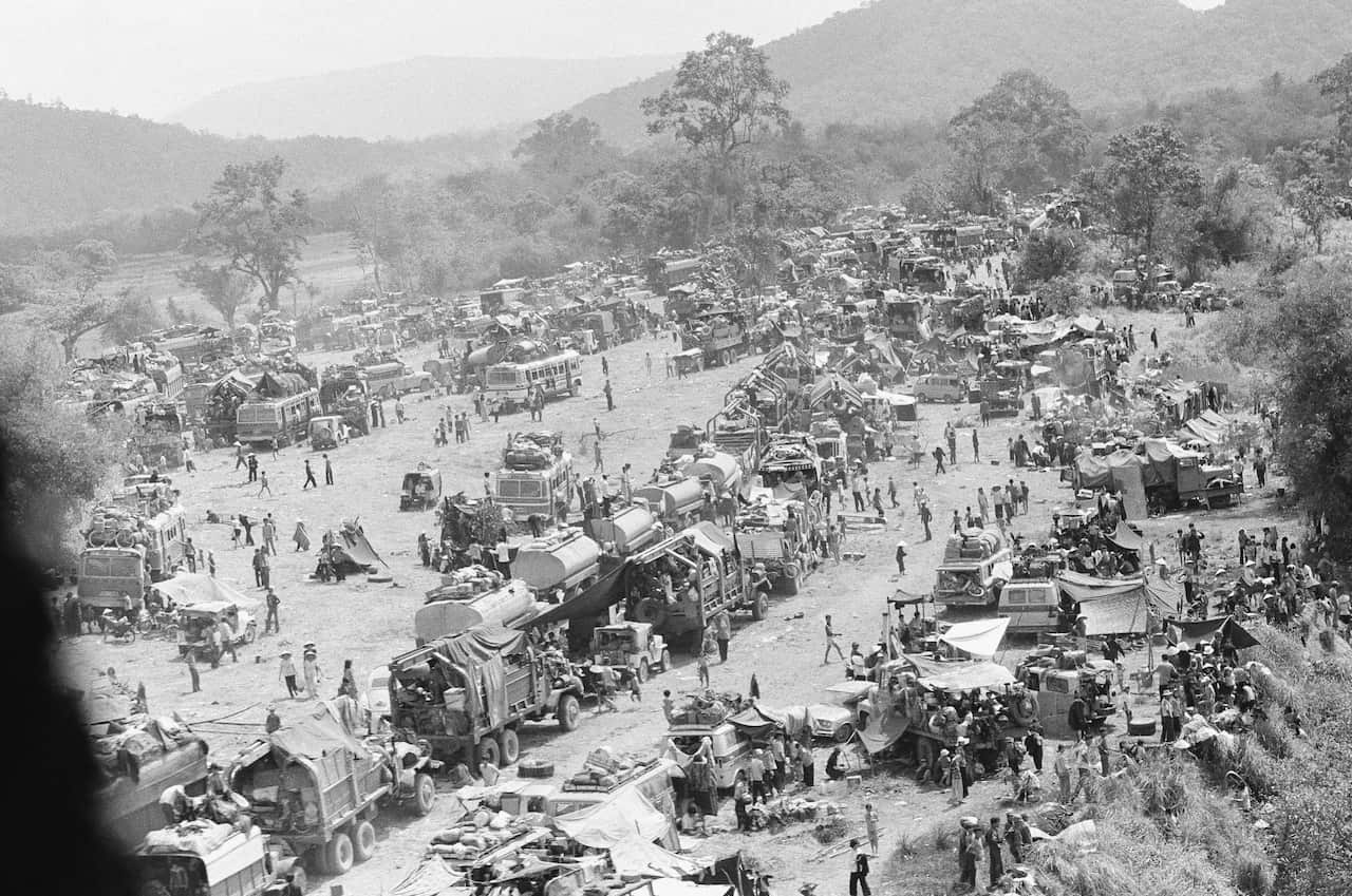 Hundreds of vehicles fill an empty area as the refugees fleeing in the vehicles pause near Tuy Hoa in the central coastal region of South Vietnam in 1975.