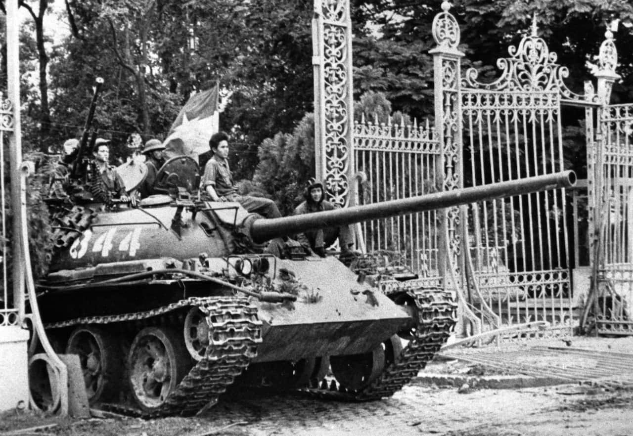 In this April 30, 1975 file photo, a North Vietnamese tank rolls through the gates of the Presidential Palace in Saigon