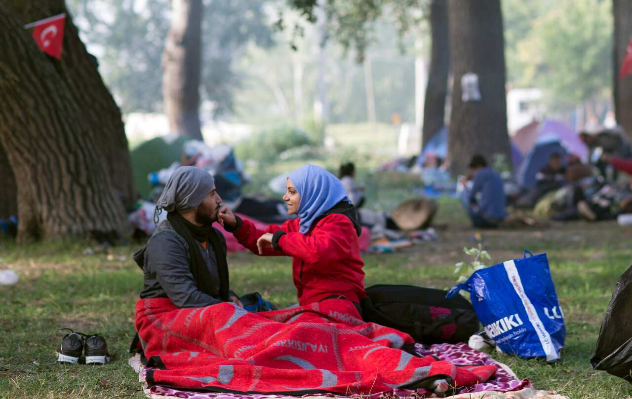 A Syrian refugees couple at Sarayici Park, where the oil wrestling arena is located, as they wait for permission to pass the Turkish-Greek border in Edirne, Turkey, 20 September 2015.