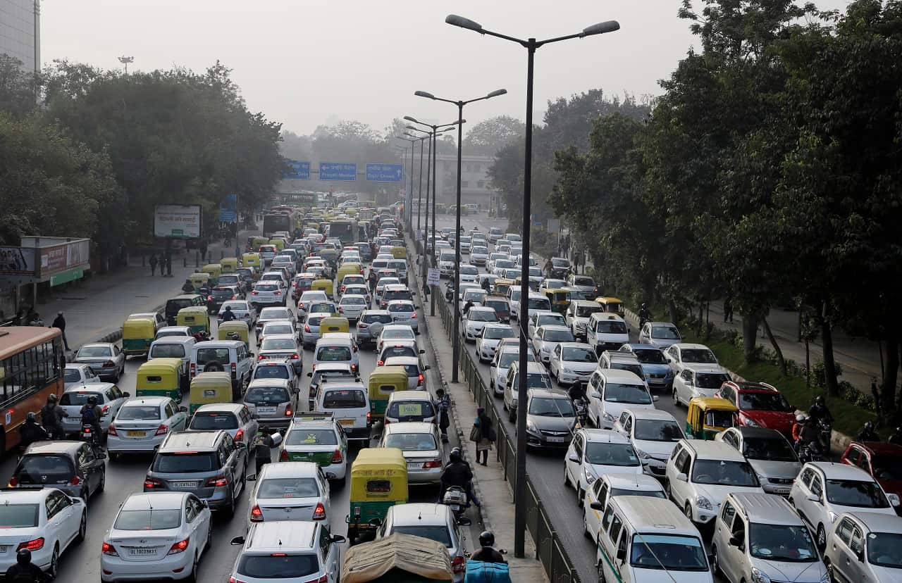 Vehicles move slowly at a traffic intersection after the end of a two-week experiment to reduce the number of cars to fight pollution in in New Delhi.