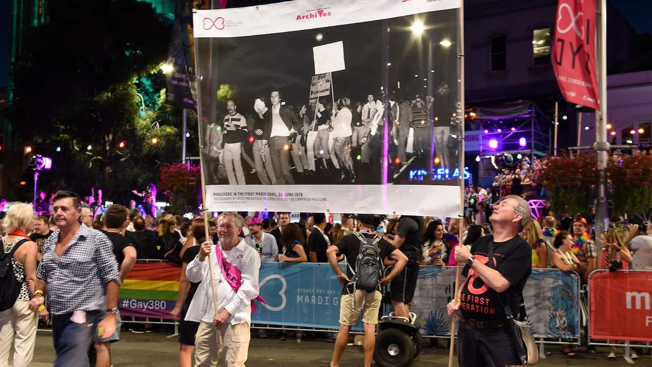 Members of the first Mardi Gras in 1978 are seen holding a photograph of the original protest, while taking part in the 38th annual Gay and Lesbian Mardi Gras parade, in Sydney, Saturday, March 5, 2016. Organisers say this year's parade will involve 10,00