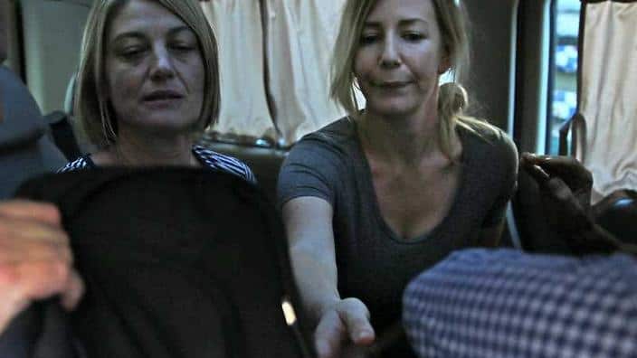Australian TV journalist Tara Brown, left, and Sally Faulkner, right, the mother of the two Australian children, sit in a minivan after they were released 