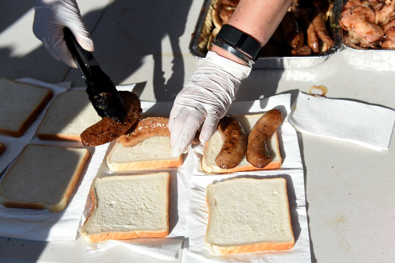 Sausage sandwiches are prepared for sale at a polling station in the seat of Lindsay, for Federal Election in Sydney, Saturday, July 2, 2016. (AAP Image/Paul Miller) NO ARCHIVING