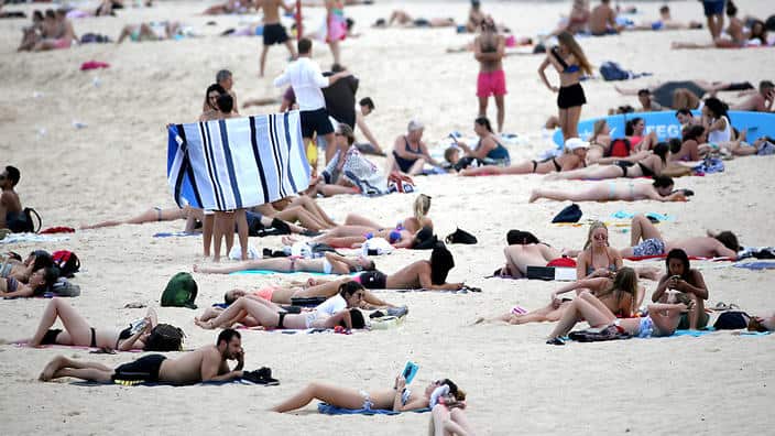 People sit in the sunshine on Coogee beach in Sydney, Thursday, Dec. 1, 2016. (AAP Image/David Moir) NO ARCHIVING