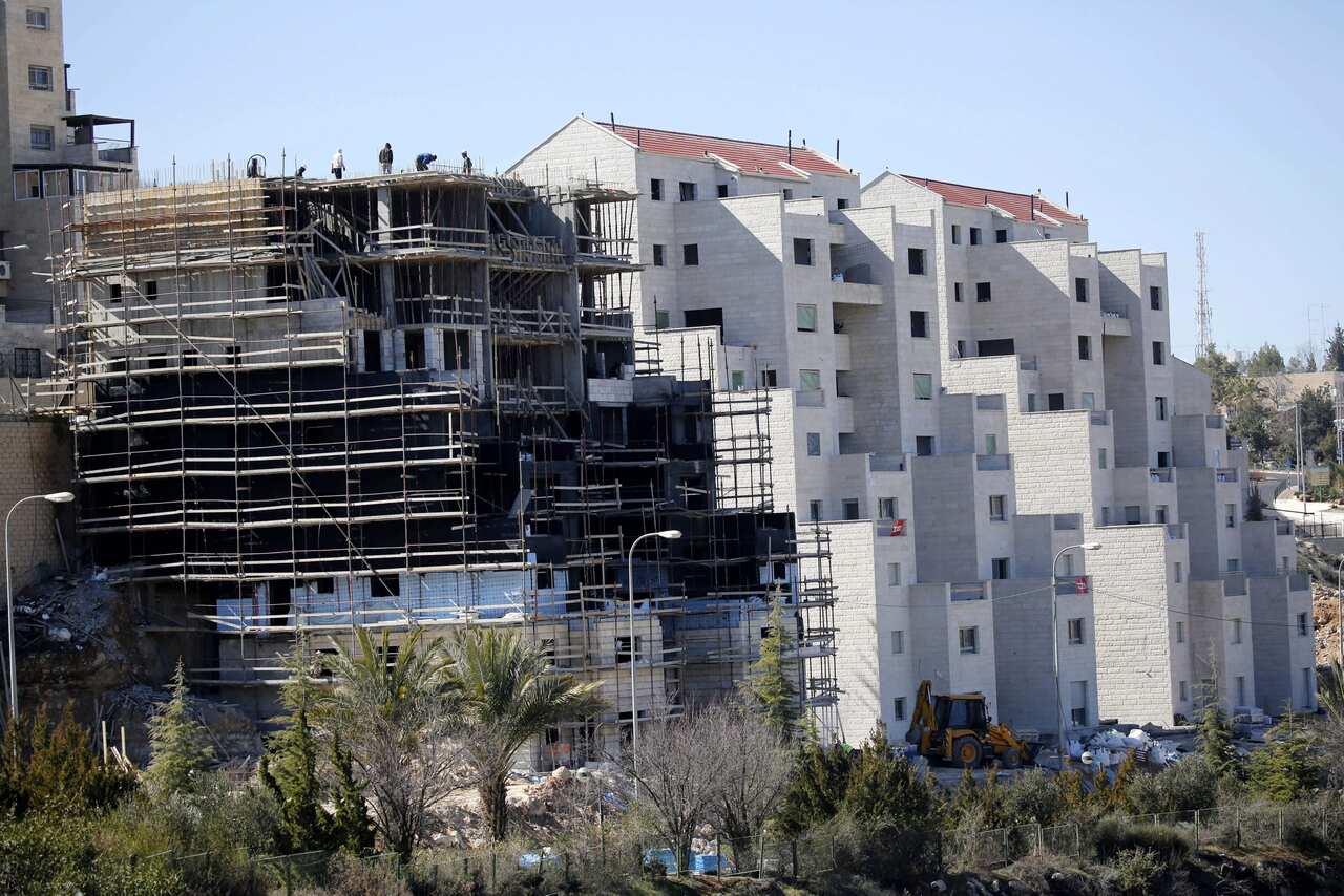 Builders work in a new construction in Kiryat Arba settlement near the West Bank city of Hebron, 07 February 2017. 
