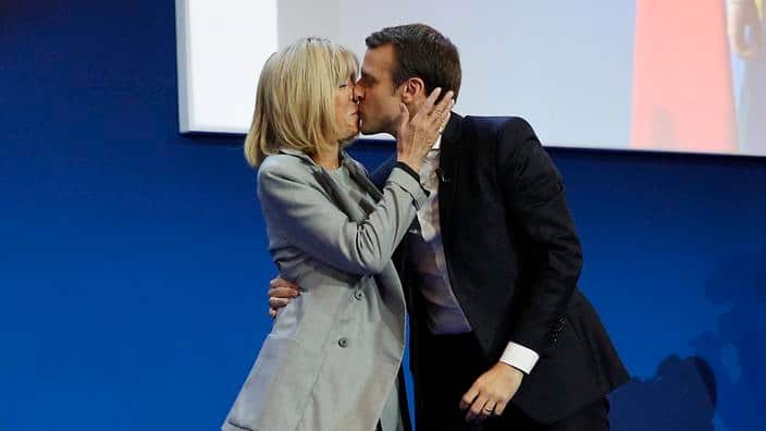  French presidential election candidate for the 'En Marche!' (Onwards!) political movement, Emmanuel Macron (R) kisses his wife his wife Brigitte Trogneux (L) (EPA) 