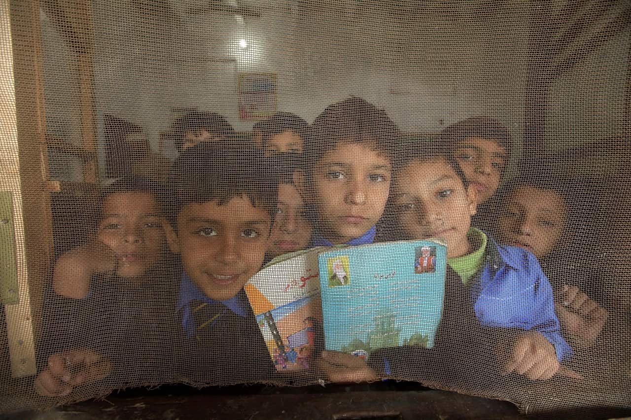 Pakistani boys pose as they attend school.