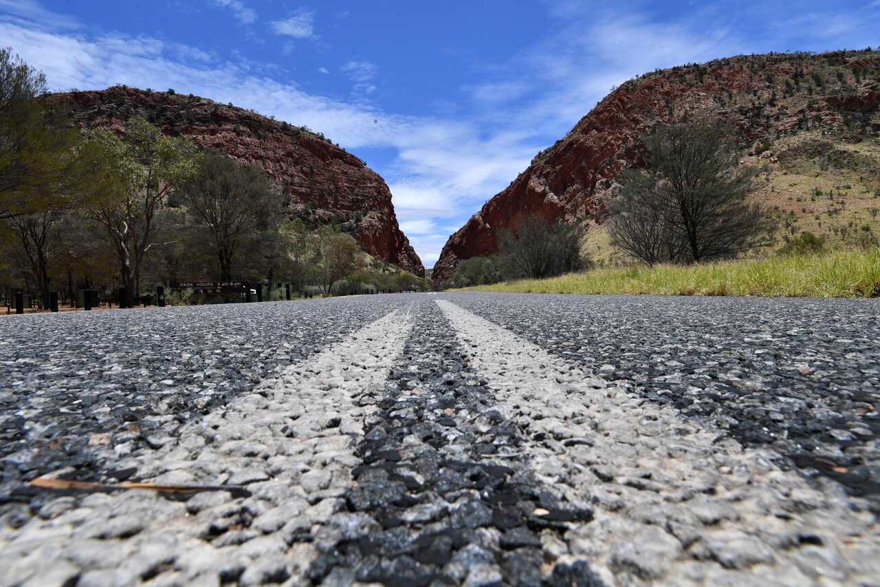 A general view of the road leading towards Simpsons Gap, which is situated in the West MacDonnell Ranges, near the Northern Territory city of Alice Springs, Sunday, January 14, 2018. (AAP Image/Darren England) NO ARCHIVING