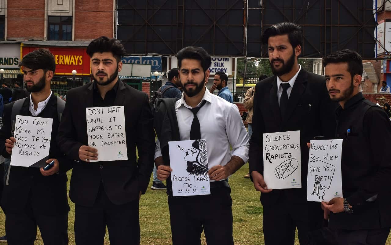 Kashmiri students hold placards during a protest calling for justice.