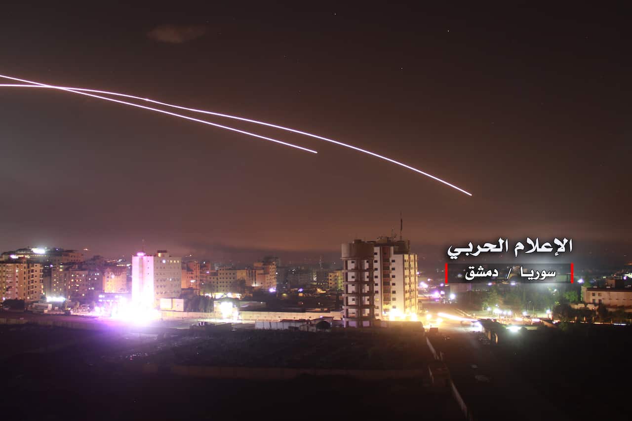 A handout photo made available by government-affiliated Syrian Military Media is said to show Syrian air defense intercepting missile strikes over Damascus