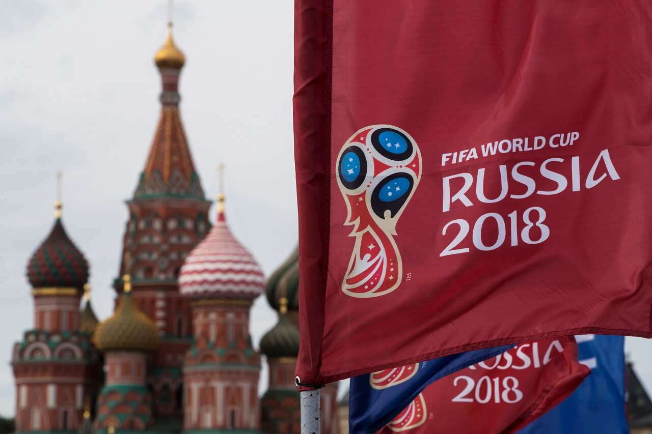 A flag with the logo of the World Cup 2018 on display with the St. Basil's Cathedral in the background, in Moscow, Russia, Monday, June 4, 2018. (AP Photo/Pavel Golovkin)