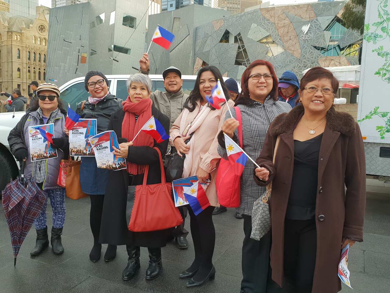 Filipinos from various community groups joining the flag-raising ceremony