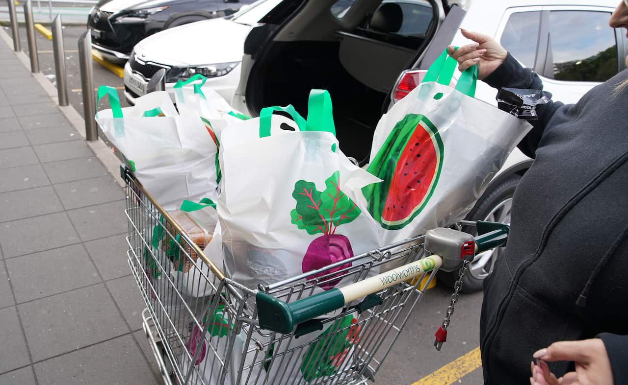 A lady unloads her re-useable plastic bags provided by Woolworths at Wolli Creek after the ban on single use plastic bags .Sydney, Australia.MondayJuly 2,2018. (AAP Image/Ben Rushton) NO ARCHIVING