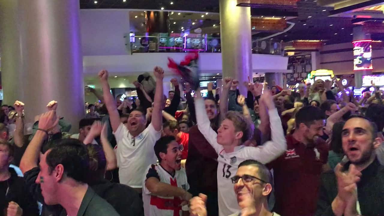 Fans react to England's goal while watching coverage of the FIFA World Cup 2018 quarter-final match against Sweden at the Star Casino in Sydney