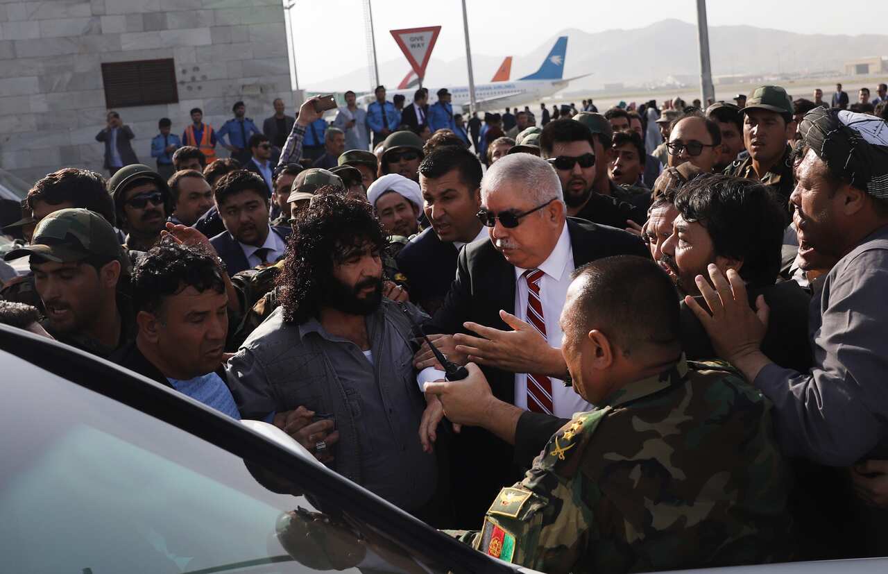 epa06904649 Afghan exiled voice president, Abdul Rashid Dustom (C) among his supporters as he arrives at the Hamid Karzai international airport, Kabul, Afghanistan, 22 July 2018. Few minutes after Dostom's arrival a suicide attacker targeted his convoy wh