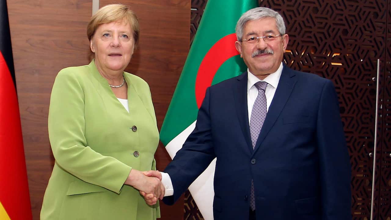 German Chancellor Angela Merkel shakes hands with Algerian Prime Minister Ahmed Ouyahia ahead of talks in Algiers, Monday Sept.17, 2018. Merkel is visiting Algeria for a day to promote bilateral ties and discuss migration and the situation in neighboring 