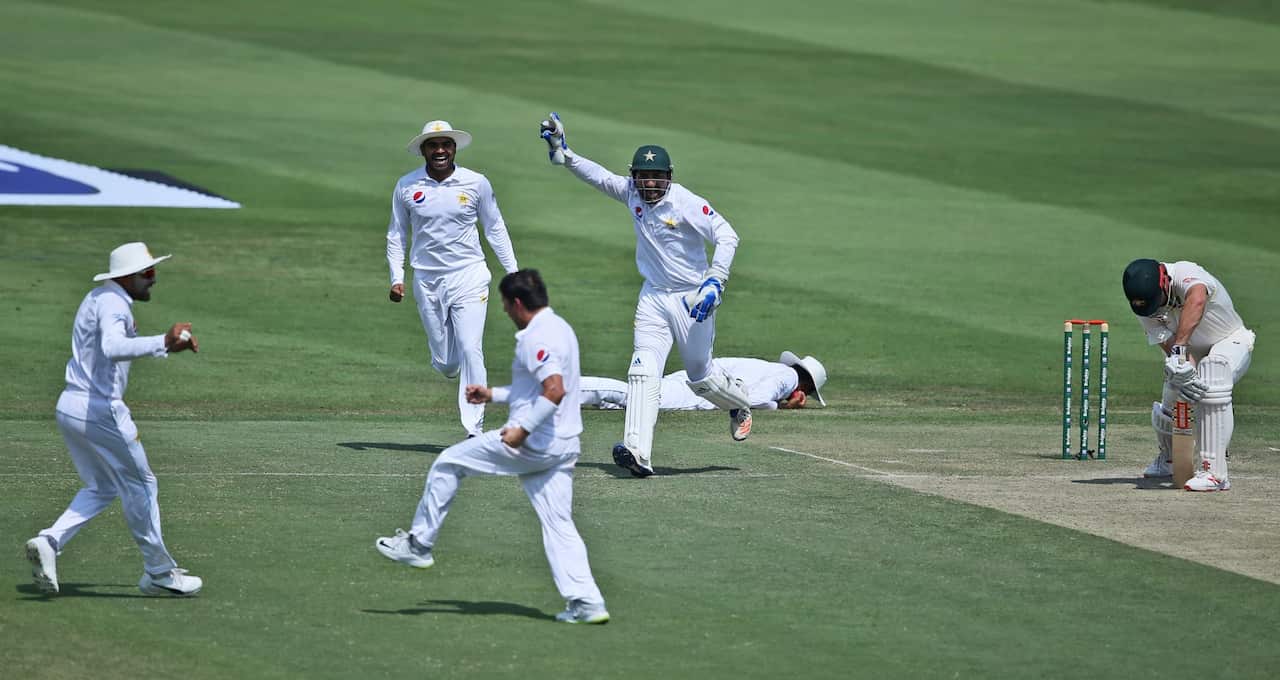 Pakistan's players celebrate dismissal of Australia's Mitchell Marsh during their test match in Abu Dhabi, United Arab Emirates, Wednesday, Oct. 17, 2018. (AP Photo/Kamran Jebreili)