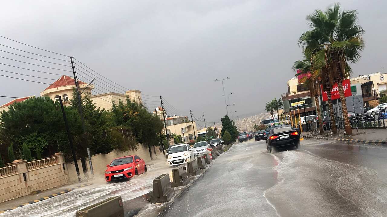 6 Vehicles wade through rain water after a sudden thunderstorm, at a street of Amman, Jordan, 25 October 2018. According to local media sources at least 18 people, most of them children, have died after torrential sudden rain swept away a school bus carry