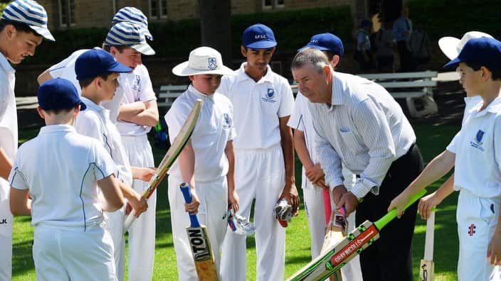 Former test cricket player Rod Marsh is seen coaching students from St Peters College in Adelaide on St Peters Oval.
