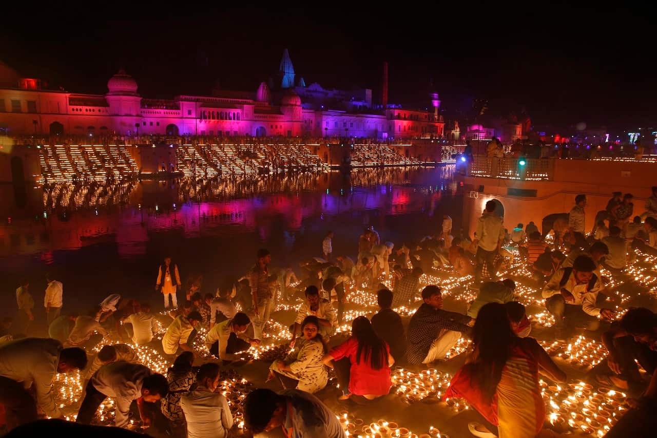 Devotees light earthen lamps on the banks of the River Sarayu as part of Diwali celebrations in Ayodhya, India,