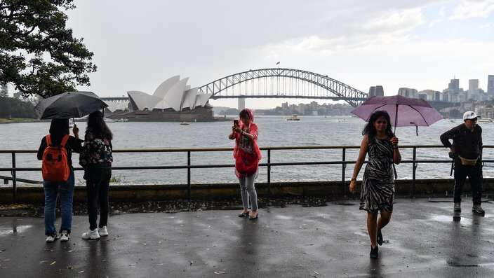 Tourists are seen at Mrs Macquarie's Chair in Sydney.