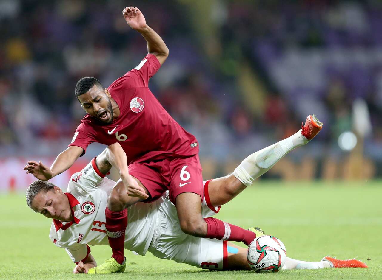 Abdelaziz Hatim (R) of Qatar in action against George Felix Melki of Lebanon 