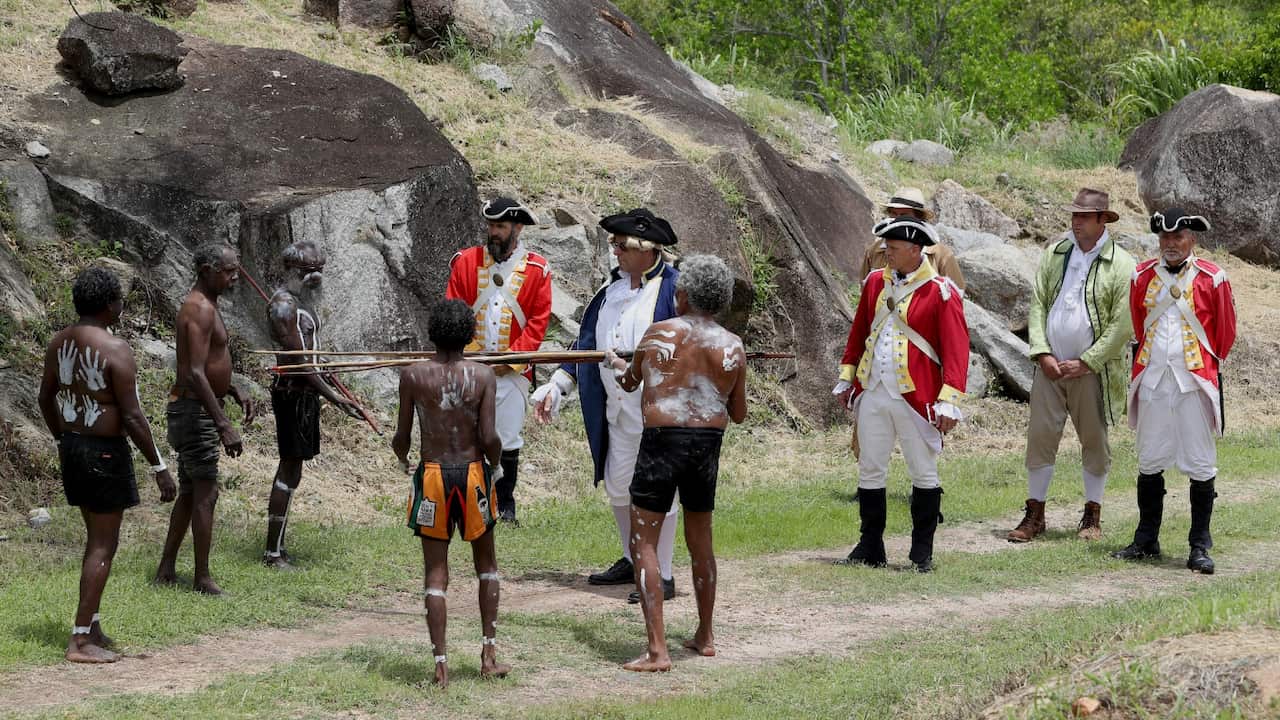 Members of the Guugu Yimithirr tribe reenact the landing of James Cook 249 years before at Reconciliation Rocks in Cooktown. 