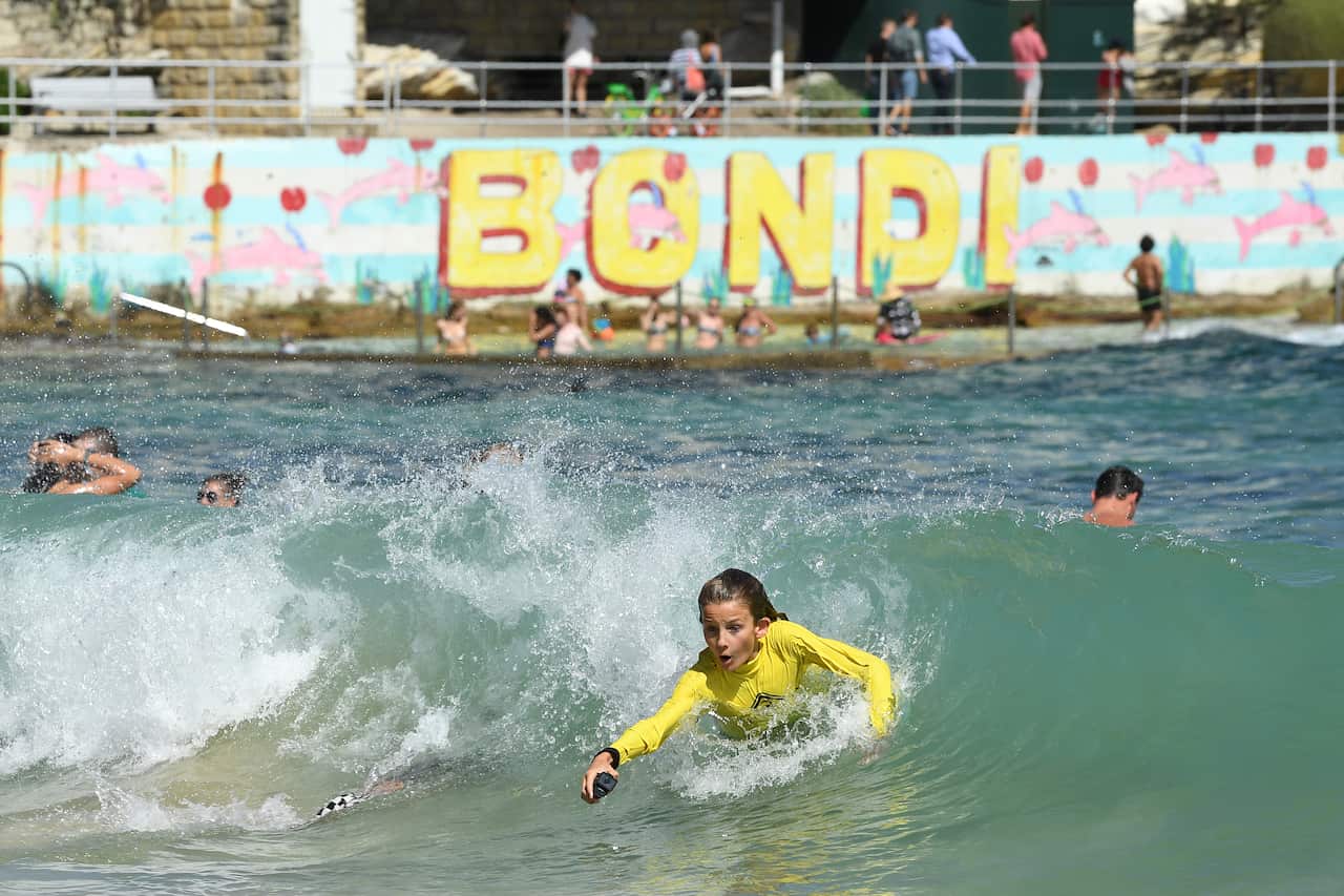 Beachgoers cool off in the water at Bondi Beach in Sydney, Tuesday, February 12, 2019. (AAP Image/ Joel Carrett) NO ARCHIVING