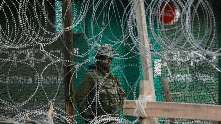 An Indian paramilitary soldier stands guard  during a strike in protest against the ban on Jama'at-e-Islami, Srinagar, India