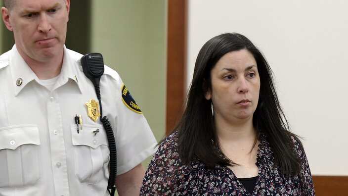 Erika L. Murray, charged in the deaths of two babies whose remains were found in her squalid home, is led into Superior Court, Tuesday, June 4, 2019 in Worcester, Mass. (Rick Cinclair/Worcester Telegram & Gazette via AP)