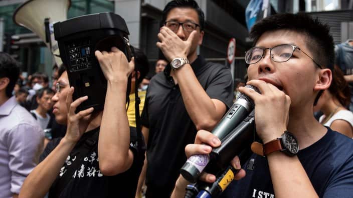 Joshua Wong, co-founder of the Demosisto political party, speaks to the protester gathered at the police headquarters. Despite the Chief Executive Carrie Lam's attempt to ease the heightened tension by agreeing to suspend the controversial extradition bil